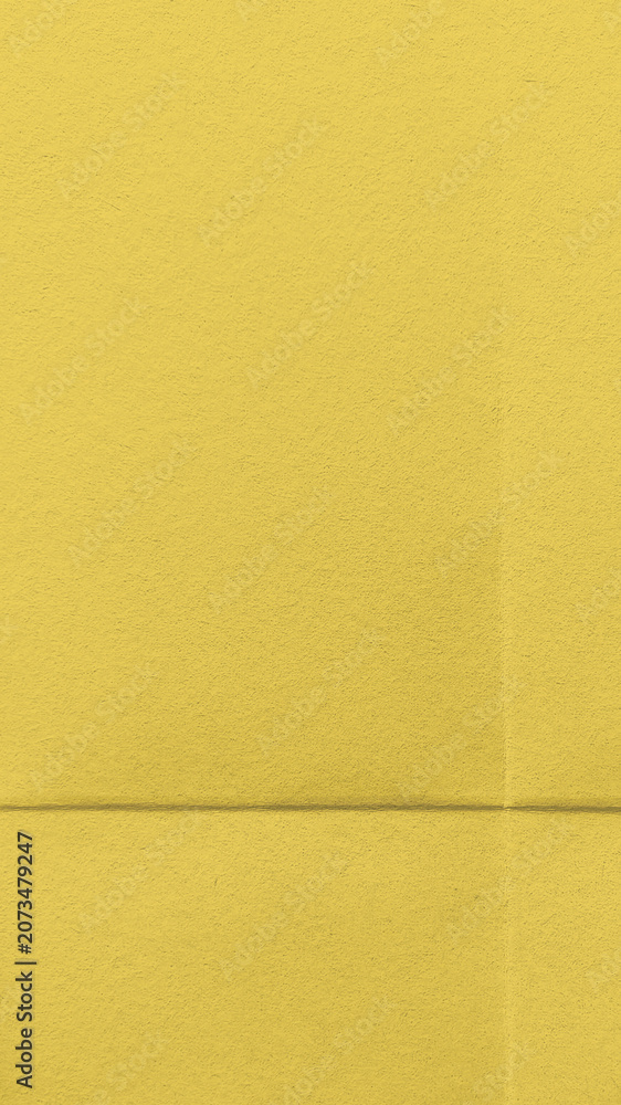 Fototapeta premium Bright textured yellow wallpaper for mobile