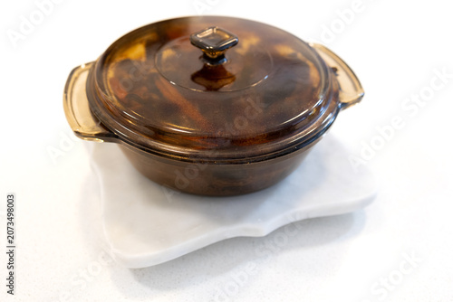 Fotografie Roasted duck with carrots in a glass pot inside an oven