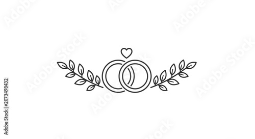 Two simple wedding rings are decorated with leaves and a heart