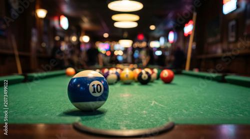 Foto Billiard 10 ball on green pool table in a bar setting