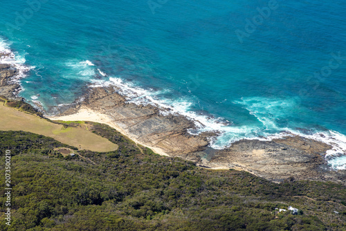 Marengo aerial view of rocky shoreline and sandy beach and coastal vegetation, Victoria Australia