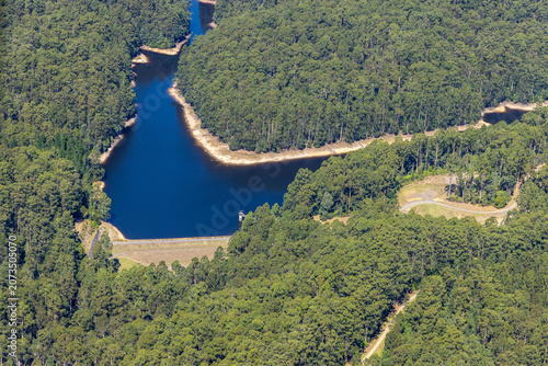Beech Forest aerial view of West Barwon Reservoir and surrounding forest and winding road, Victoria Australia