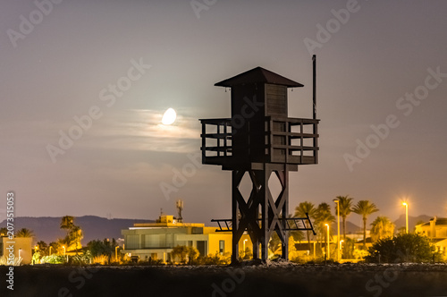 Solitary Coast Guard Lookout Station Lit by Moonlight Near the Sea