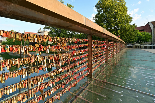 Fényképezés Love Locks on Butchers' Bridge over Ljubljanica River in Ljubljana, Slovenia on clear sunny summer morning
