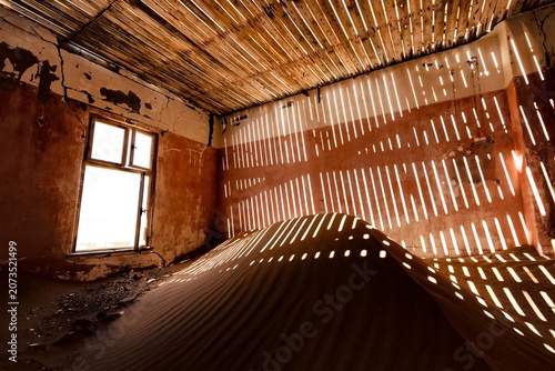 Cuadro en lienzo Sunset in Kolmanskop, room buried by sand in an old mining town, Namibia