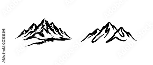 Hand drawn ink wash mountain peak sketches showing artistic brush texture and paint flow.