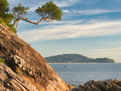 Obraz na plátně Large weathered granite rock formations with distinct slabs highlighted by lush vegetation clinging to the cliffs are a tourist attraction in khanom district nakhon si thammarat province