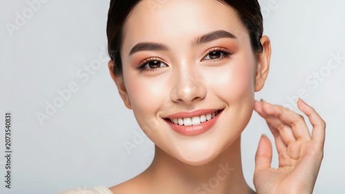 Radiant Beauty: A young woman with flawless skin and a warm smile exudes natural beauty and confidence, her gaze direct and engaging.