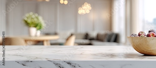 A modern, softly lit interior showcases a marble countertop with a bowl of fresh fruit, creating a serene and inviting atmosphere.