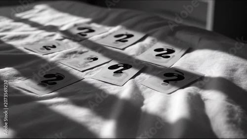 Cards with number two arranged on a white surface with sunlight