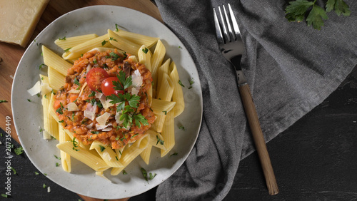 Konstfotografi Penne pasta topped with a hearty lentil bolognese sauce