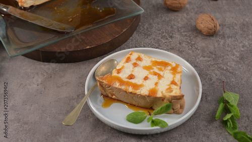 Slice of cake topped with syrup and fresh mint
