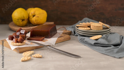 Marmelada de marmelo with crackers on a wooden board
