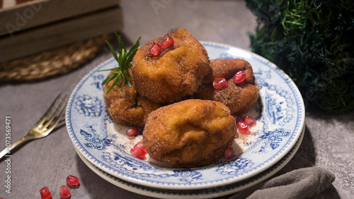 Traditional fried dough fritters topped with pomegranate seeds