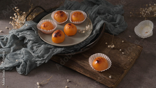 Portuguese quindim custard treats arranged on a rustic tray