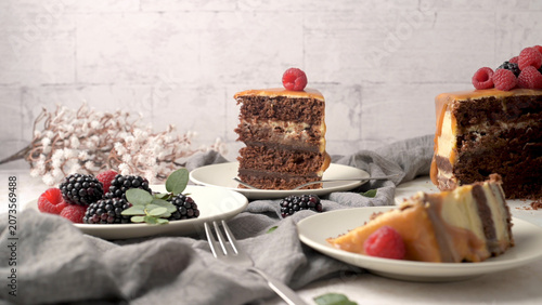 Decadent layered chocolate cake with caramel drip and fresh berries