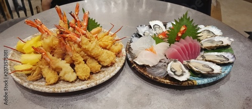 Platters of seafood and fried food dishes displayed on a table
