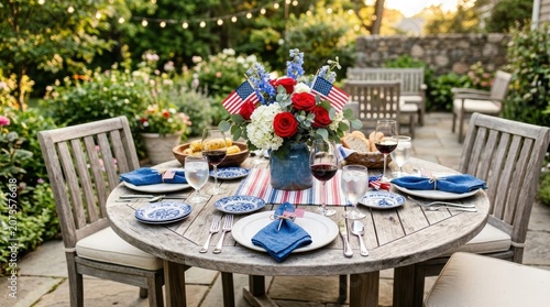 Festive outdoor dining table set for a patriotic celebration with flowers and American flags