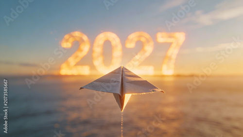 Paper airplane flying towards glowing 2027 text in representing future goals business planning strategy vision success and new year aspirations concept