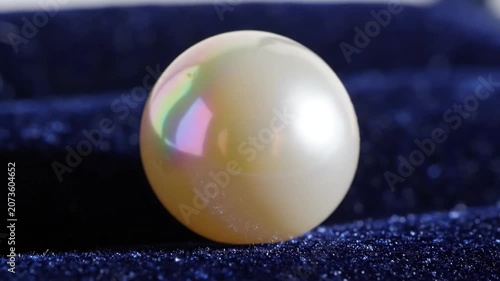 Static Macro Shot Of A Pearl Resting On A Smooth Surface
