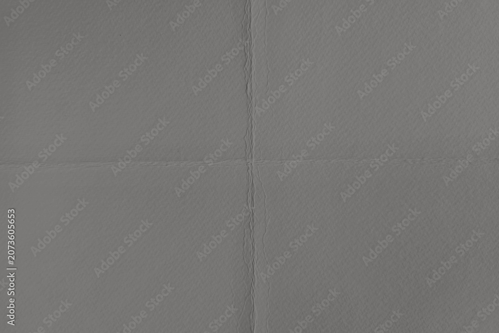Fototapeta premium Textured gray paper background with subtle folds