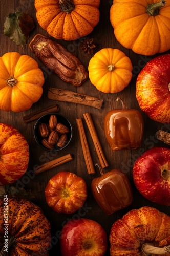 Variety of Pumpkins Apples and Spices on Wooden Surface