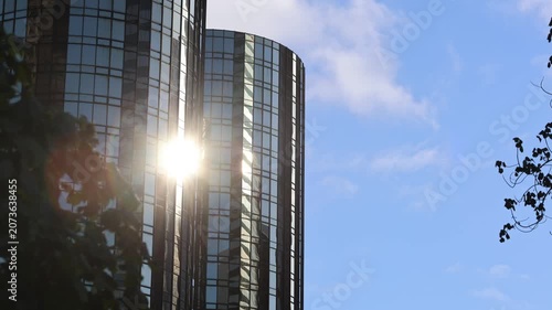 Sun Reflecting Off Mirrored Building With Blue Sky