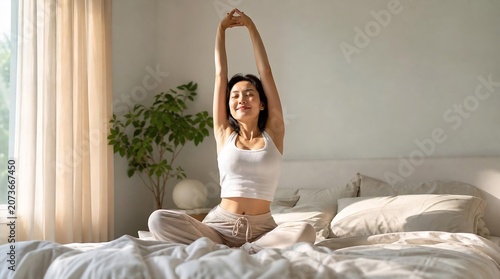 Peaceful Asian woman stretching on bed for morning ritual