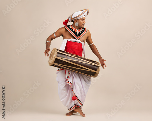 Sri Lankan Traditional Geta Beraya (Kandyan Drum) Musician in a Minimal Backdrop