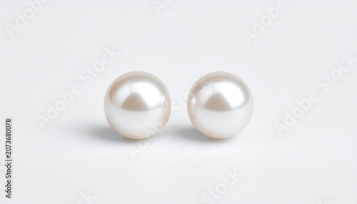 Pair of White Pearl Earrings on White Background.
