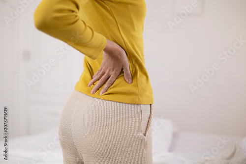 The young woman complained of lower back pain. She also experienced pain and stiffness in her shoulders, neck, and back, along with muscle spasms and general discomfort.