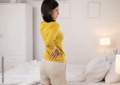 The young woman complained of lower back pain. She also experienced pain and stiffness in her shoulders, neck, and back, along with muscle spasms and general discomfort.