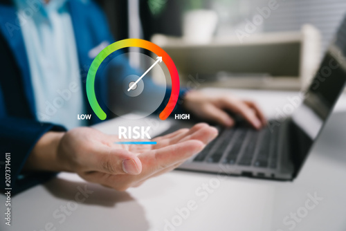 Fototapeta kuchenna Risk assessment and business management concept with high level gauge, virtual dashboard and professional working on laptop
