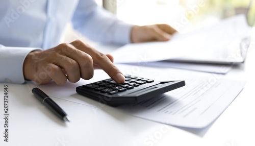 Close up of Hands Using Calculator and Checking Financial Invoices