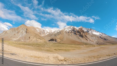 4K shot of clouds above the Himalayan mountain range with snowy peaks during the summer season as seen near Sarchu on Leh Manali highway. Scenic view of the Himalayas during the summer season.