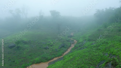 4K shot of a muddy water stream in the Sahyadri hills during the ongoing rain in monsoon season as seen from Saputara in Gujarat, India. Scenic natural background with copy space. Monsoon in Sahyadri.