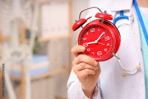 Female doctor with red alar...