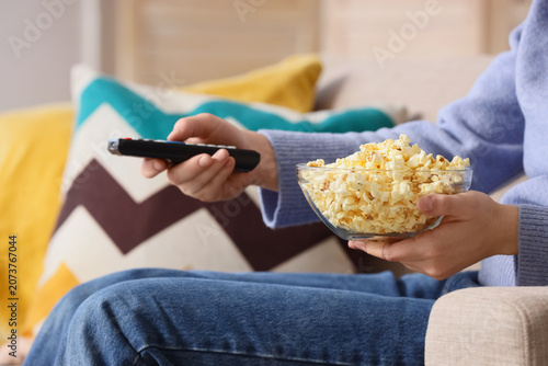 Woman with tasty popcorn wa...