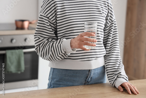 Young woman with glass of w...