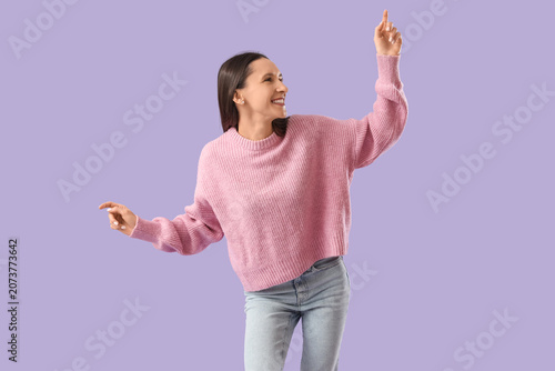Happy young woman on lilac ...