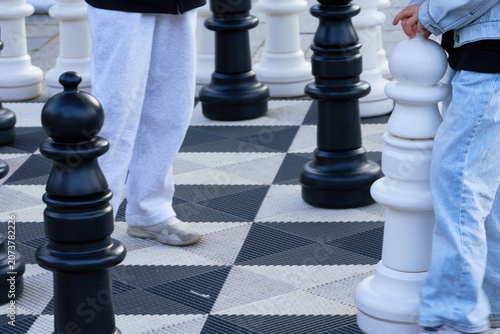 Large chess pieces on the city streets.  Black and white pieces.