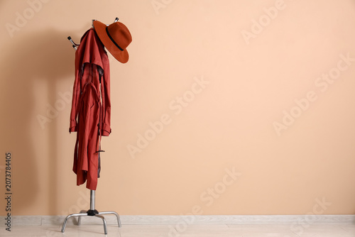 Rack with coat and felt hat...