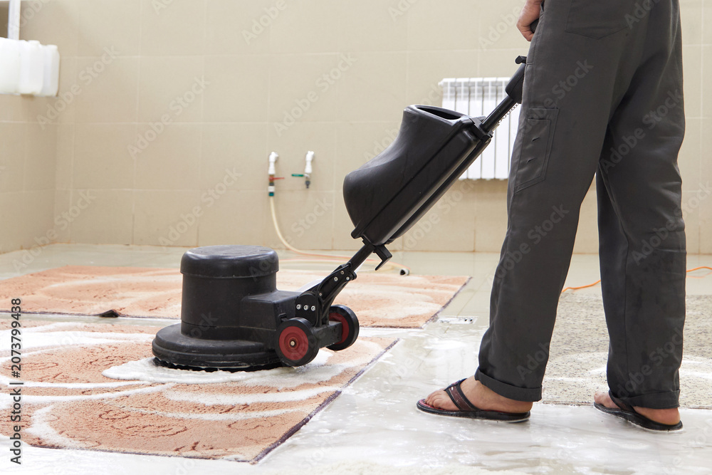 Fototapeta premium Carpet chemical cleaning with professionally disk machine. Early spring cleaning or regular clean up.