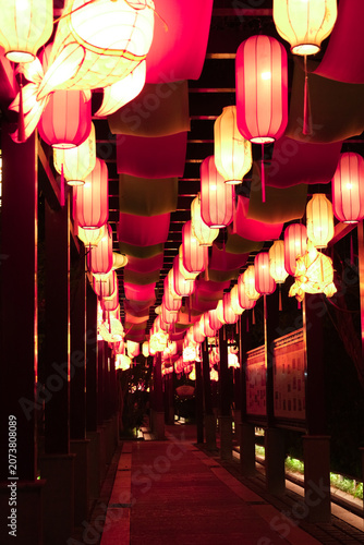 Glowing lanterns along a night walkway