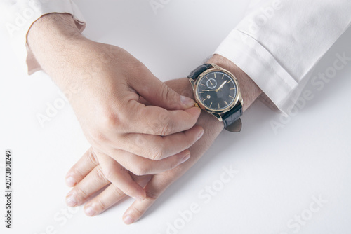 Картината върху платно Close up of a male doctor checking his wristwatch
