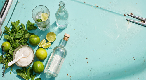 Overhead flat lay of Cuban Mojito cocktail ingredients on vintage car metal