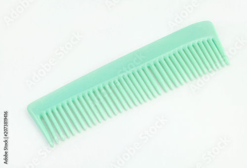 Mint green plastic hair comb isolated on white background