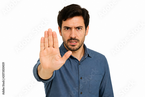 A man with a concerned expression is holding up his hand in a stop gesture against a white background.