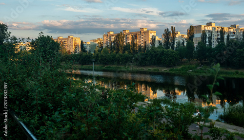 Obraz na plátně Kyiv's residential buildings lining the urban canal, bathed in warm evening ligh