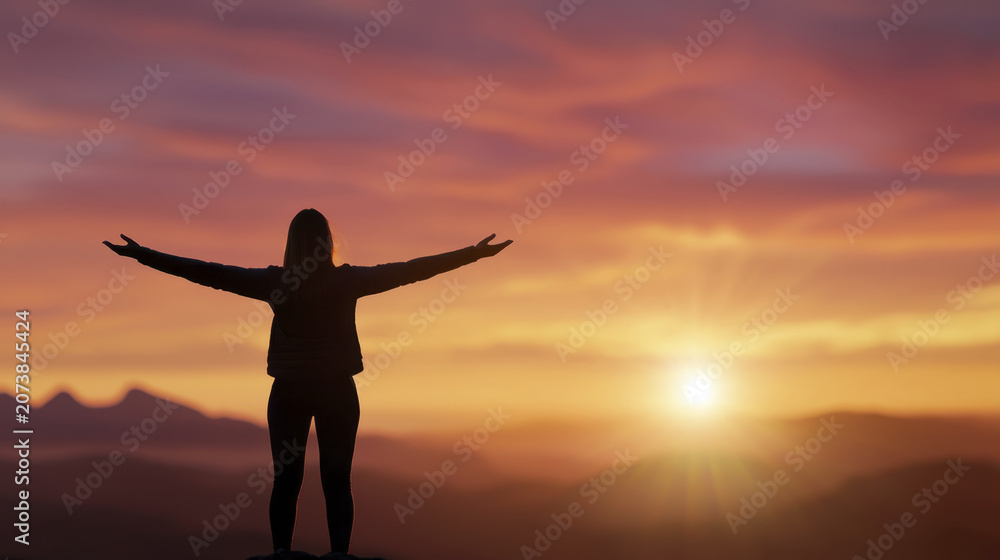 Fototapeta premium Woman embracing sunset light with open arms, enjoying beauty of nature and moment of tranquility